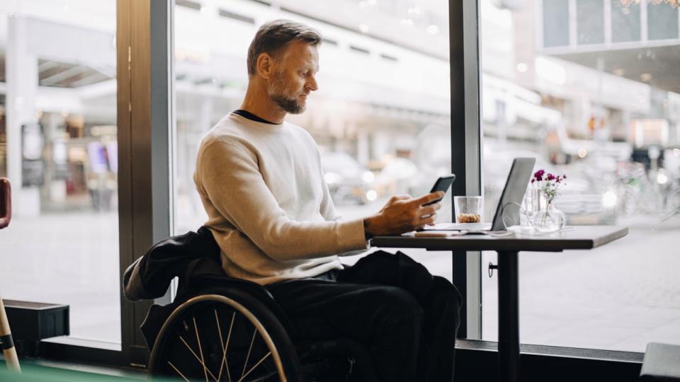 man in wheelchair working in a cafe