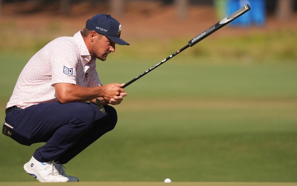 Bryson DeChambeau lines up a putt on the seventh hole during the third round