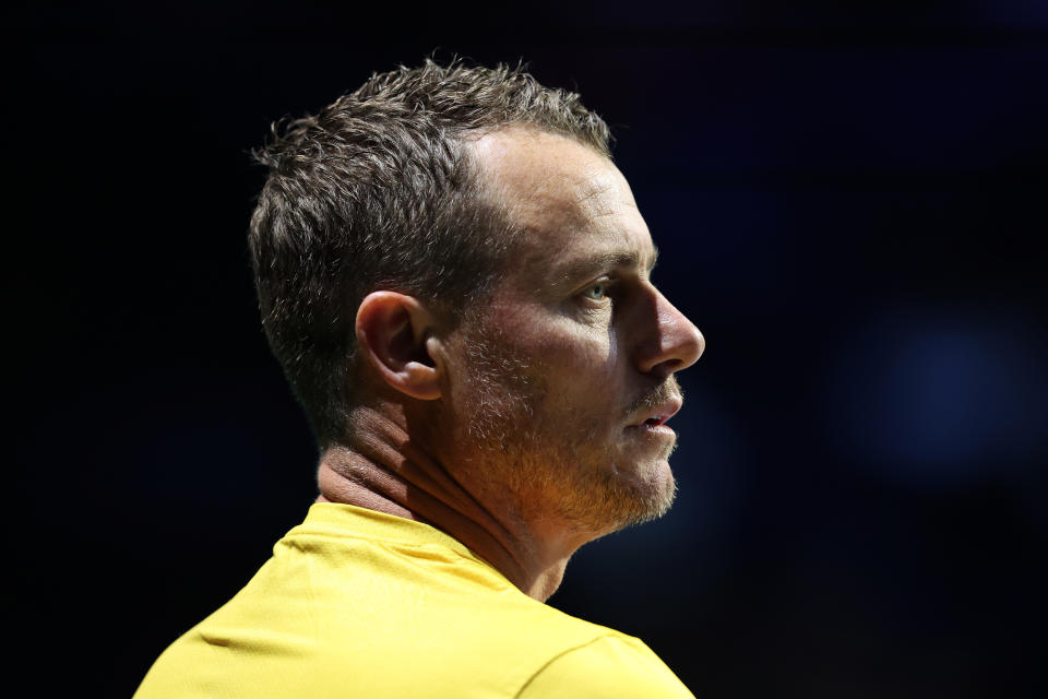 Lleyton Hewitt watches on.