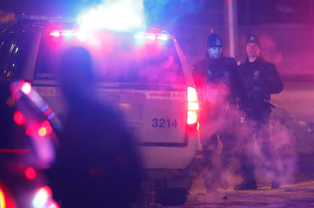 Police officers are seen near a mosque after a shooting in Quebec City. REUTERS/Mathieu Belanger