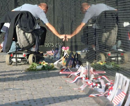 Dave Zacchetti points to a name on the Vietnam Veteran's Memorial on Veteran's Day in Washington, in this November 11, 2006 file photo.REUTERS/Stelios Varias/Files