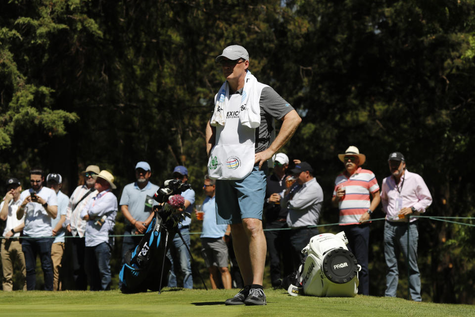 Shawn Spieth serving as caddie for his son Jordan Spieth, stands on the green during the first day of competition of the WGC-Mexico Championship at the Chapultepec Golf Club in Mexico City, Thursday, Feb. 21, 2019. Spieth’s father caddied nine holes of practice Wednesday and will be on the bag the rest of the week after Spieth's caddie left because of the death of his father. (AP Photo/Marco Ugarte)