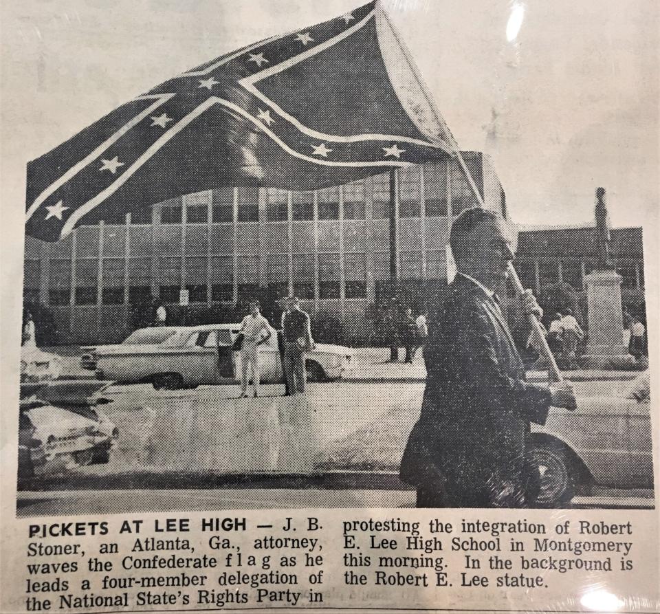File photo from 1964 edition of The Thunderbolt. "J.B. Stoner, an Atlanta, Ga., attorney, waves the Confederate flag as he leads a four-member delegation of the National State's Rights Party in protesting the integration of Robert E. Lee High School in Montgomery this morning. In the background is the Robert E. Lee statue.