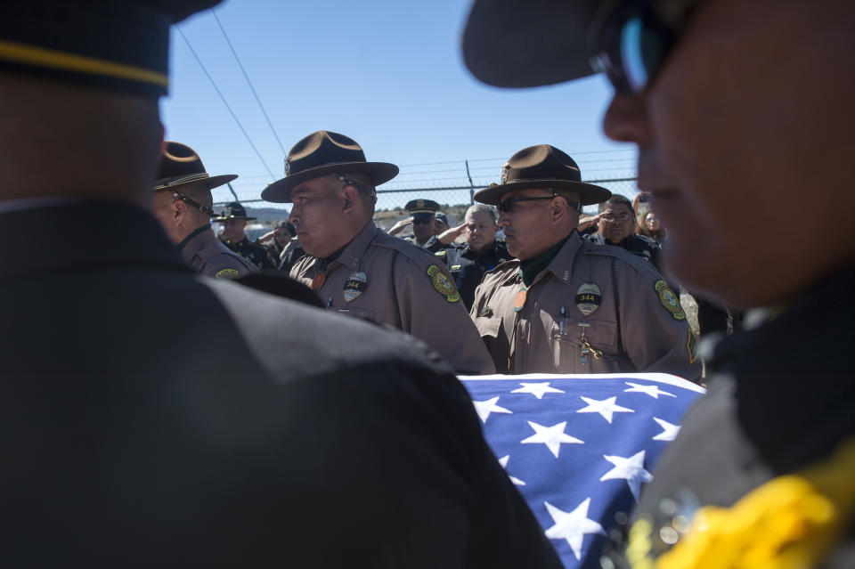 FILE - In this March 16, 2017 file photo Navajo Nation police officers and McKinley County Sheriff officers carry the casket of fallen Navajo Nation police officer Houston Largo to his final resting place in Sunset Memorial Park in Gallup, N.M. A man who gunned down a tribal police officer in a remote corner of the nation's largest American Indian reservation has been sentenced to 30 years in federal prison.(Cayla Nimmo/Gallup Independent via AP,File)