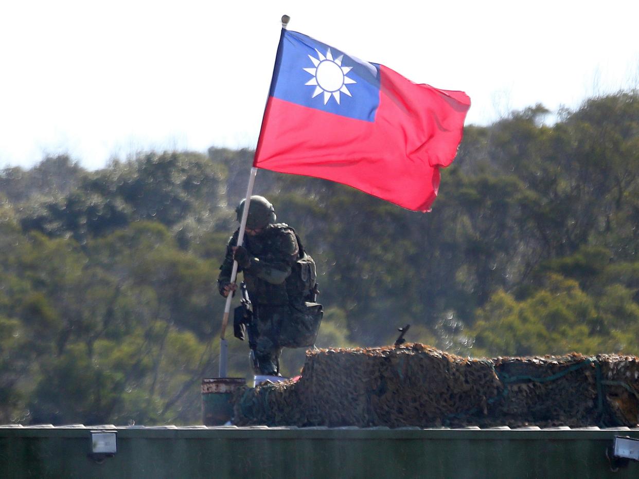 A soldier holds a Taiwanese flag during a military exercise aimed at repelling an attack from China (AP)