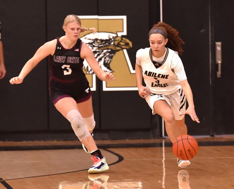 Abilene High's Samia Cooper, right, brings the ball up court as Hawley's Ryland Trojcak defends in the first half. AHS beat Hawley 51-33 in the non-district game Friday at Eagle Gym.
