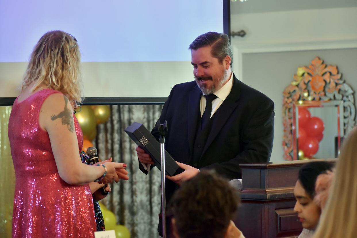 Former New Paltz Mayor Jason West receives the inaugural New Paltz Pride Award from Eve Papp, president of the New Paltz Pride Coalition.