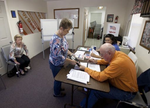 Poll workers check the identification of a voter in the tiny precinct of Smith Creek on November 6, in Sopchoppy, Florida. US President Barack Obama's top aide in Florida said Democrats have won the vote in the officially undeclared Sunshine State, where officials are under fire for mishandling the ballot