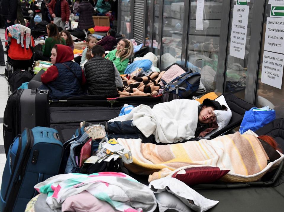 People rest at a refugee reception center at the Ukrainian-Polish border crossing in Korczowa, Poland, March 5, 2022.