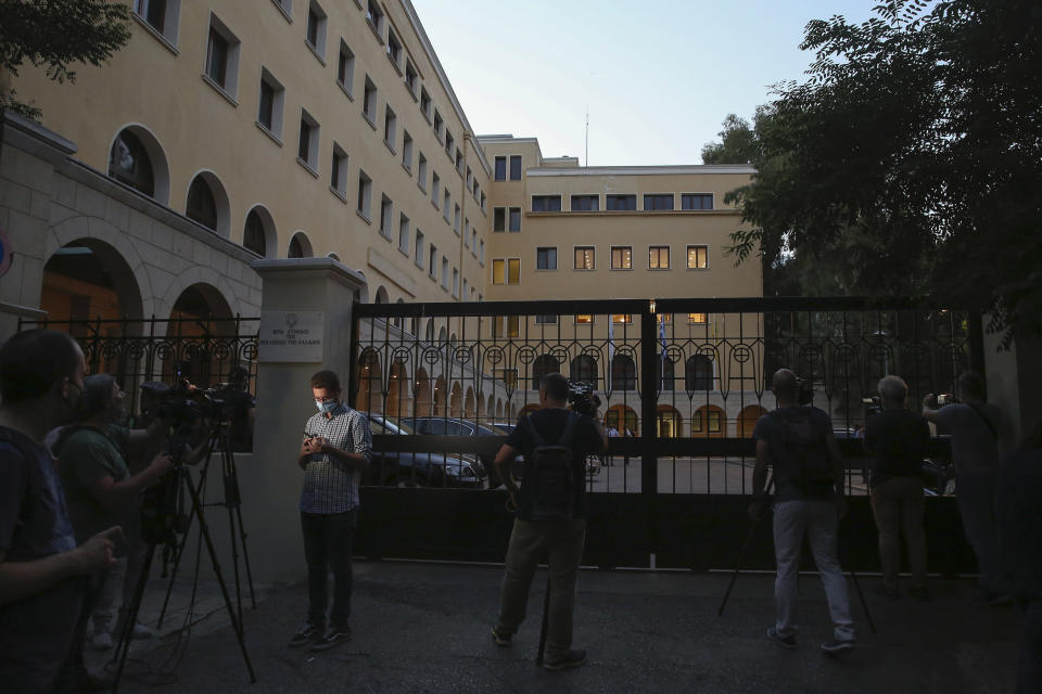 Journalists and cameramen stand outside Petraki Monastery in Athens, following an attack with a caustic liquid on Wednesday, June 23, 2021. Greek authorities say seven Greek Orthodox bishops have been hospitalized after allegedly being attacked with a caustic liquid by a priest facing a disciplinary hearing in Athens. The incident occurred at a meeting of senior church officials late Wednesday. (AP Photo/Petros Giannakouris)