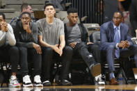 Injured Vanderbilt sophomore guard Aaron Nesmith, second from right, wears a walking boot as he watches his teammates play Texas A&M in an NCAA college basketball game Saturday, Jan. 11, 2020, in Nashville, Tenn. Nesmith is the SEC's leading scorer and fifth nationally averaging 23 points a game. Texas A&M won 69-50. (AP Photo/Mark Humphrey)