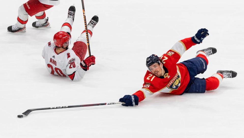 Florida Panthers center Nick Cousins (21) and Carolina Hurricanes center Sebastian Aho (20) compete for the puck in the third period of Game 4 of the NHL Stanley Cup Eastern Conference finals series at the FLA Live Arena on Wednesday, May 24, 2023 in Sunrise, Fla.