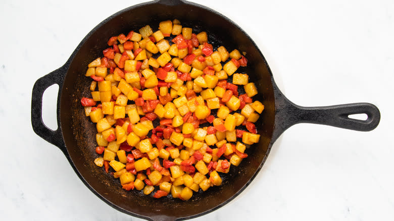 potato and bell pepper cooking in skillet