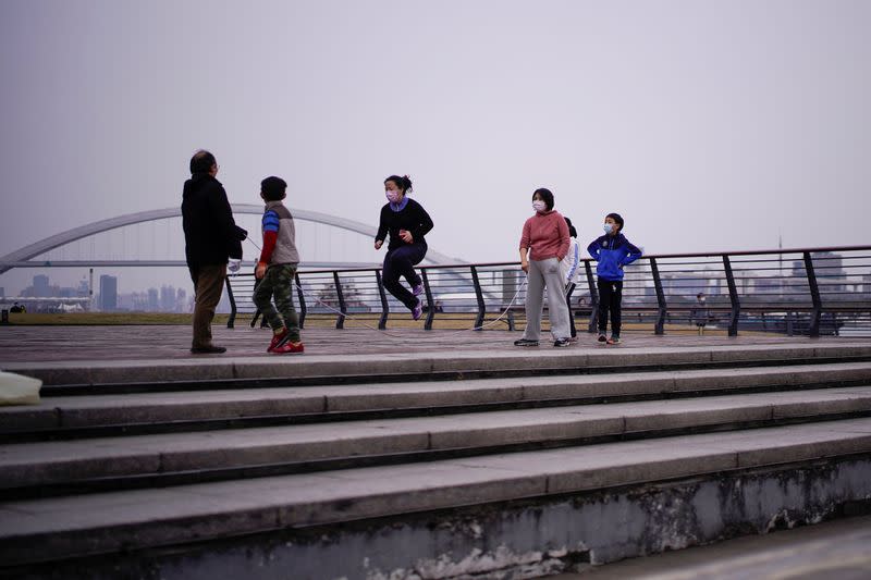 People wearing face masks jump rope at a park, as the country is hit by an outbreak of the novel coronavirus, in Shanghai