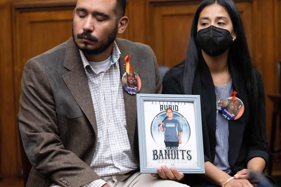 Felix and Kimberly Rubio, parents of 10-year-old Alexandria Rubio who was killed during the shooting at Robb Elementary School in Uvalde, Texas, in May 2022, hold a photo of their daughter during a House Committee on Oversight and Reform hearing on "Examining the Practices and Profits of Gun Manufacturers," on Capitol Hill in Washington, DC, July 27, 2022.