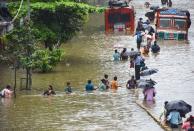 Mumbai: People wade through a waterlogged street at Parel area, after heavy monsoon rain, in Mumbai, Wednesday, Sept. 23, 2020. (PTI Photo)(PTI23-09-2020_000099A)