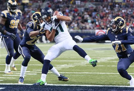 Oct 28, 2013; St. Louis, MO, USA; Seattle Seahawks wide receiver Golden Tate (81) catches a pass for a touchdown defended by St. Louis Rams cornerbacks Trumaine Johnson (23) and Janoris Jenkins (21) during the first half at Edward Jones Dome. Mandatory Credit: Nelson Chenault-USA TODAY Sports