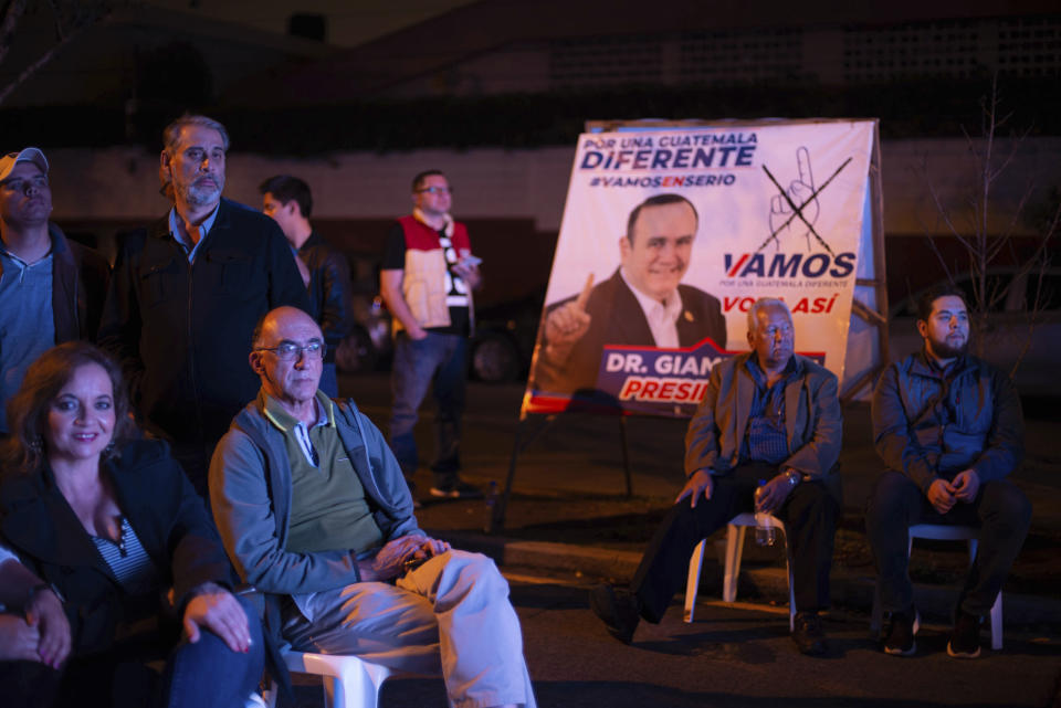 Supporters wait for Alejandro Giammattei, presidential candidate of the Vamos party, at his campaign headquarters during general elections in Guatemala City, Sunday, June 16, 2019. (AP Photo/Santiago Billy)