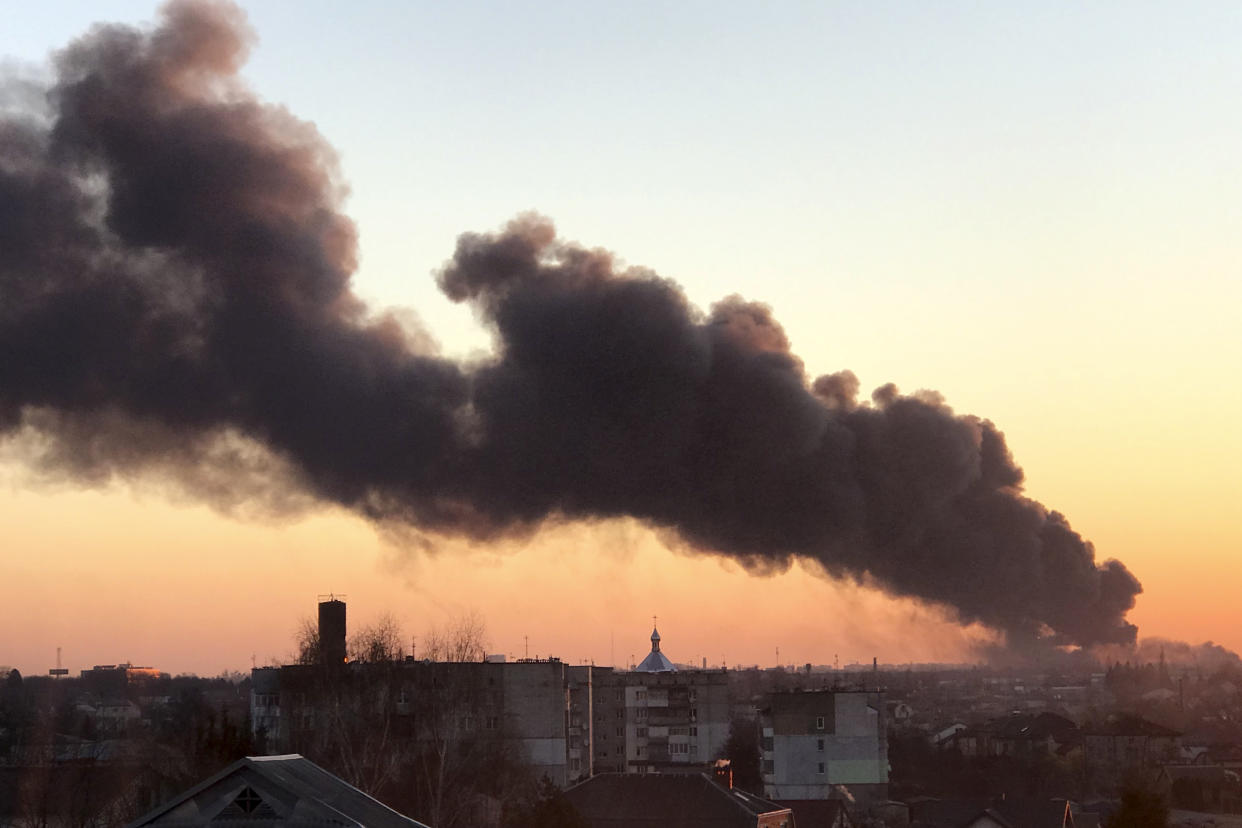 A cloud of smoke raises after an explosion in Lviv, western Ukraine, Friday, March 18, 2022. The mayor of Lviv says missiles struck near the city's airport early Friday. (AP Photo)