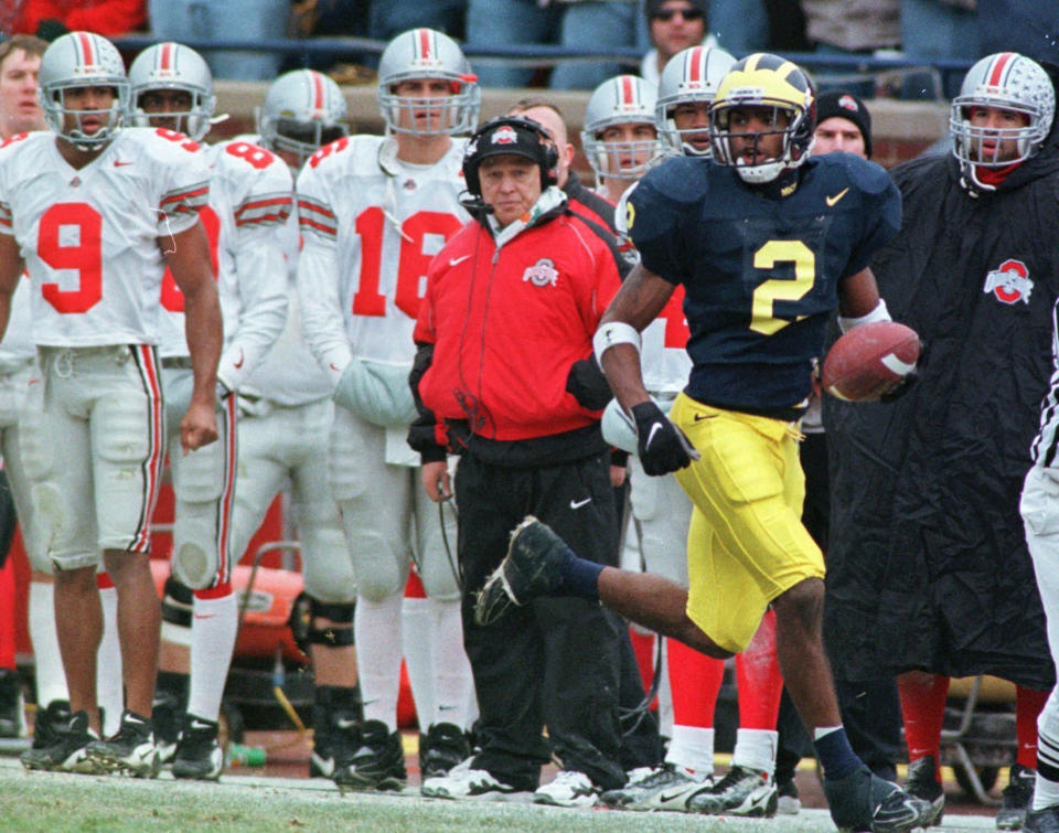 FILE - The Ohio State bench watches as Michigan's Charles Woodson returns a punt 78 yards for a touchdown during the second quarter of an NCAA college football game at Michigan Stadium in Ann Arbor, Mich., Nov. 22, 1997. (AP Photo/Duane Burleson, File)