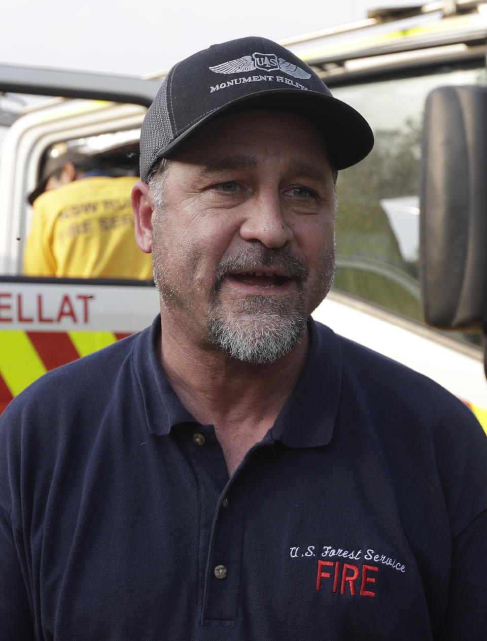 In this Jan. 10, 2020, photo, American firefighter Bill King arrives at a staging area at Candelo, Australia, before moving on to the fire brigade at Burragate. It seemed imminent to those hunkering at the fire station that "The Beast" would finally roar through. But on this night the wildfire only crept closer, prodding forward a few tentative fingers before going dormant again as the winds died. (AP Photo/Rick Rycroft)