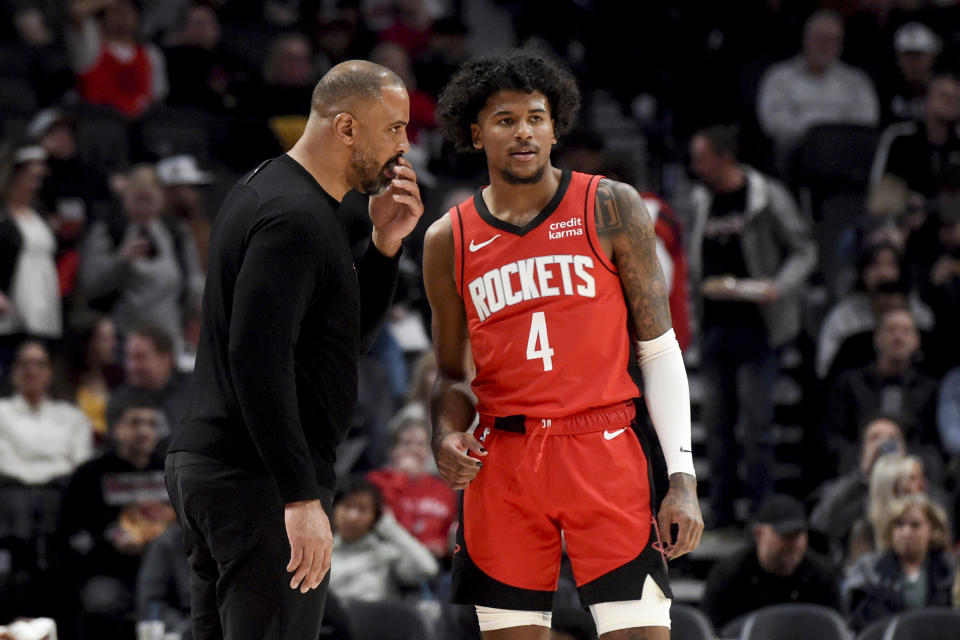 Houston Rockets head coach Ime Udoka, left, speaks with Houston Rockets guard Jalen Green (4) during the first half of an NBA basketball game against the Portland Trail Blazers in Portland, Ore., Friday, March 8, 2024. (AP Photo/Steve Dykes)