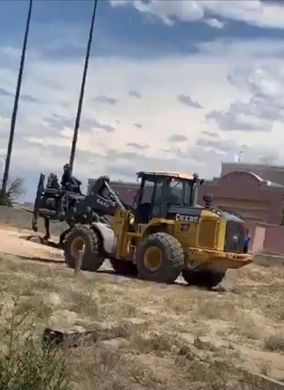 Still image from video of a vehicle carrying away a bronze statue of Spanish colonial ruler Juan de Onate in Alcalde, New Mexico