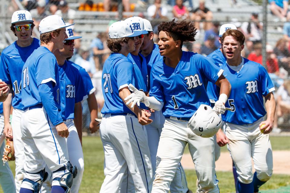 Marian's Bryce LaSane celebrates with his teammates after hitting home run during the Marian-Saint Joseph high school 3A sectional baseball game on Saturday, May 28, 2022, at Clay High School - Jim Reinebold Field in South Bend, Indiana.
