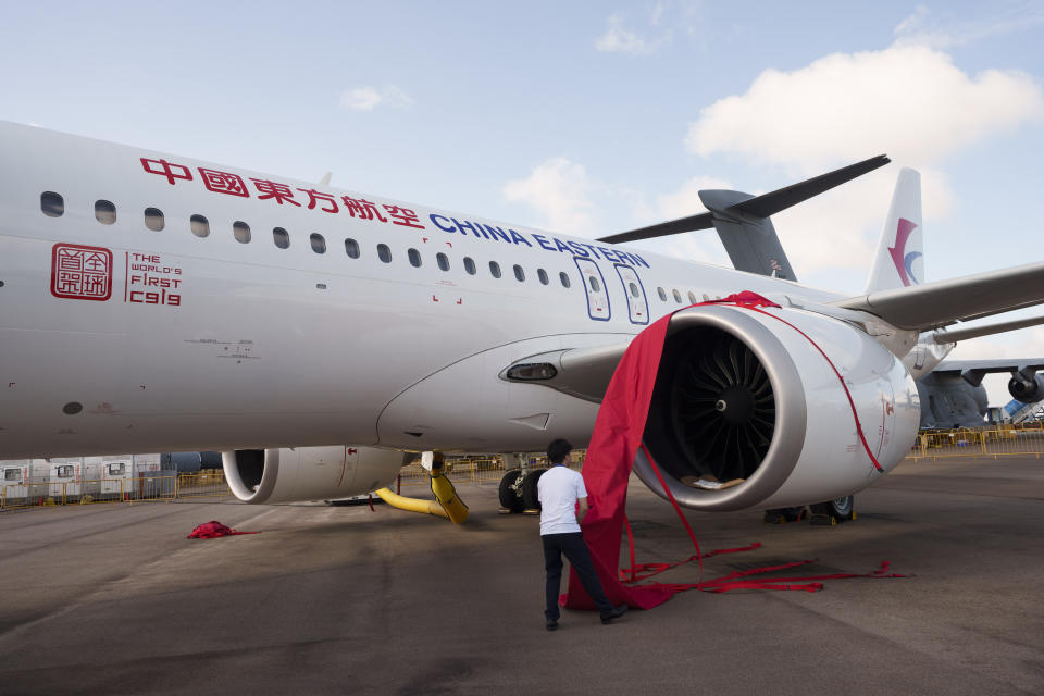 A workers prepares a China's COMAC C919 aircraft during the first day of the Singapore Airshow in Singapore, Tuesday, Feb. 20, 2024. (AP Photo/Vincent Thian)