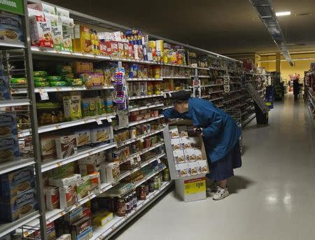 A woman looks for supplies at a Waldbaums grocery store in Long Beach, New York November 2, 2012. REUTERS/Shannon Stapleton