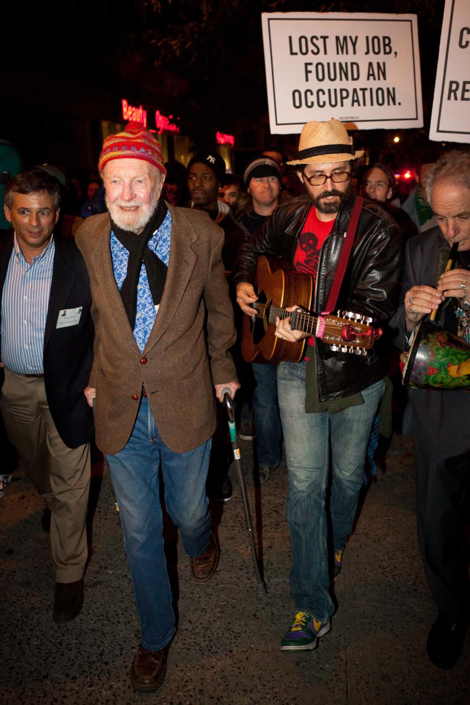 FILE - In this Oct. 21, 2011 file photo, activist and musician Pete Seeger, 92, foreground left, marches with nearly a thousand demonstrators sympathetic to the Occupy Wall Street protests for a brief acoustic concert in Columbus Circle in New York. Seeger died on Monday Jan. 27, 2014, at the age of 94. (AP Photo/John Minchillo, File)