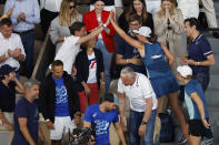 Poland's Iga Swiatek goes in the players box to celebrate with relative her victory over Coco Gauff of the U.S. during their final match of the French Open tennis tournament at the Roland Garros stadium Saturday, June 4, 2022 in Paris. Swiatek won 6-1, 6-3. (AP Photo/Jean-Francois Badias)