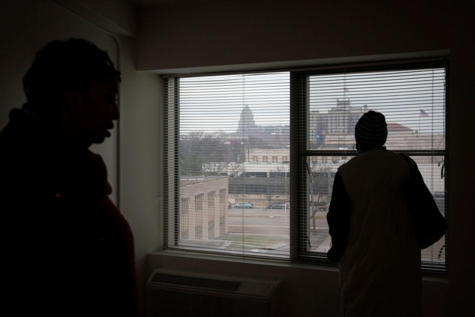 Tonya Hogan, 49, left, talks with Nicole Cloyd, a Community and Home Supports case manager, while viewing a studio apartment at the Cathedral Tower Apartments in Detroit, Tuesday, Jan. 17, 2023. Hogan decided the space was too small for both herself and her dog.