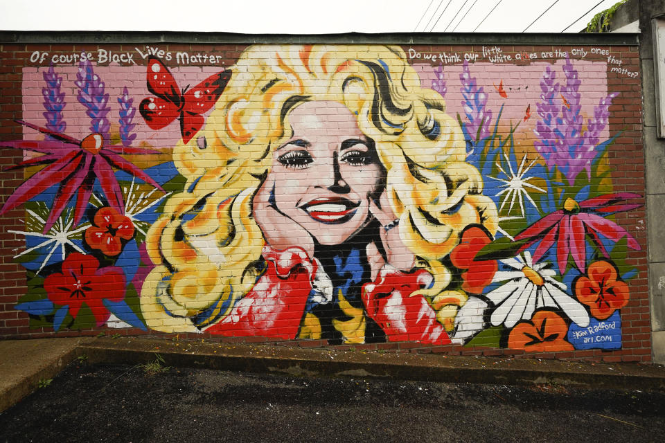 A mural of Dolly Parton is seen outside The 5 Spot, a music club in Nashville, Tenn., Friday, Aug. 21, 2020. Artist Kim Radford said Dolly fans from around the world have contacted her about the mural, which contains a quote from Parton about her support for the Black Lives Matter movement. (AP Photo/Mark Humphrey)