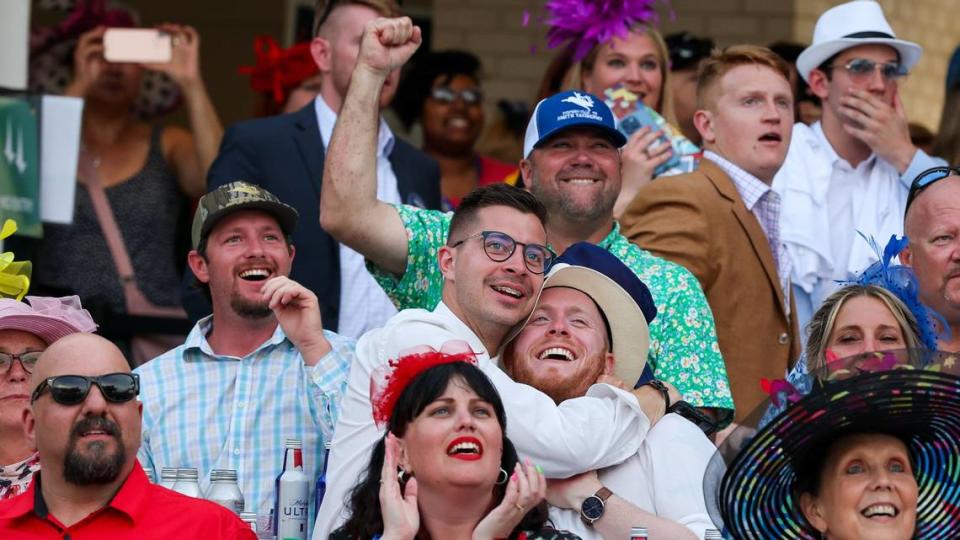 Fans in the paddock watch the Kentucky Derby on Saturday at Churchill Downs.