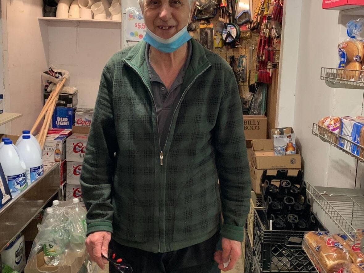 Ronald Simms, pictured in 2021 in his small store in Gaultois, says he doesn't want the town to be resettled. (Submitted by Ronald Simms - image credit)