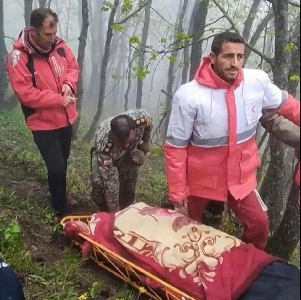Rescuers recover bodies from the site in the mountainous area of northwest Iran