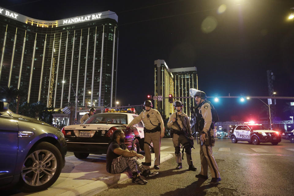 Police officers stand at the scene of a shooting near the Mandalay Bay resort and casino (AP Photo/John Locher)