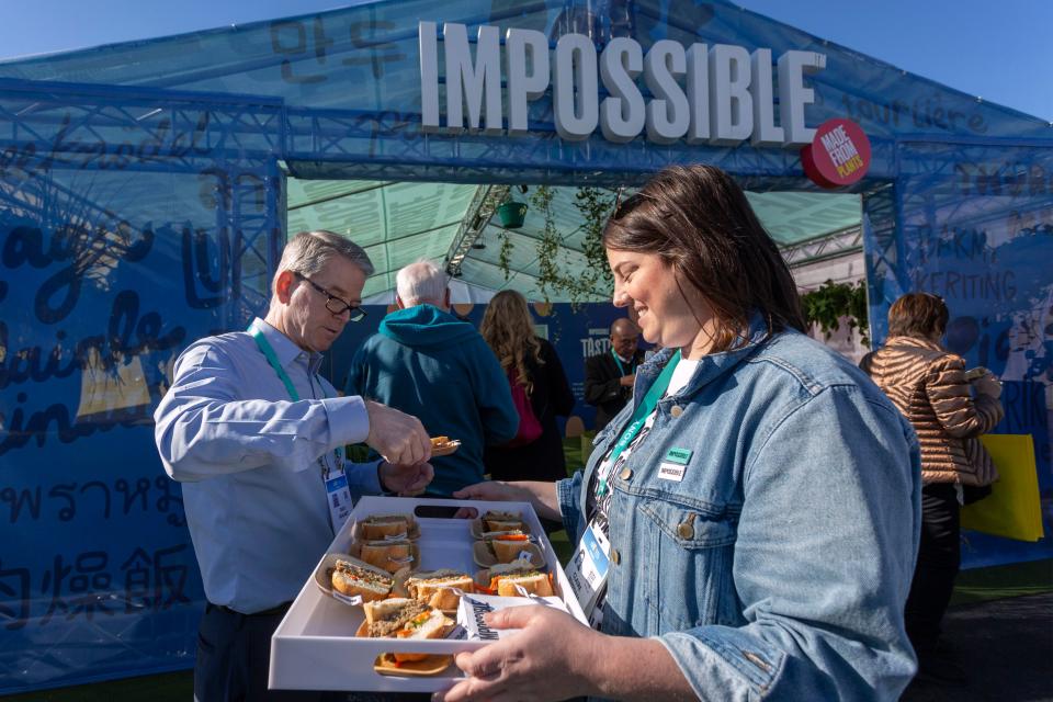 A woman serves Impossible Pork, a new plant-based pork product by Impossible Foods, at the 2020 Consumer Electronics Show (CES) in Las Vegas, Nevada on January 9, 2020. - CES is one of the largest tech shows on the planet, showcasing more than 4,500 exhibiting companies representing the entire consumer technology ecosystem. (Photo by DAVID MCNEW / AFP) (Photo by DAVID MCNEW/AFP via Getty Images)