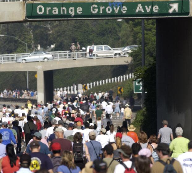 2003 photo of walkers take their turn hiking an eight-mile section of the 110 Pasadena Freeway during Sunday's Arroyo Fest.