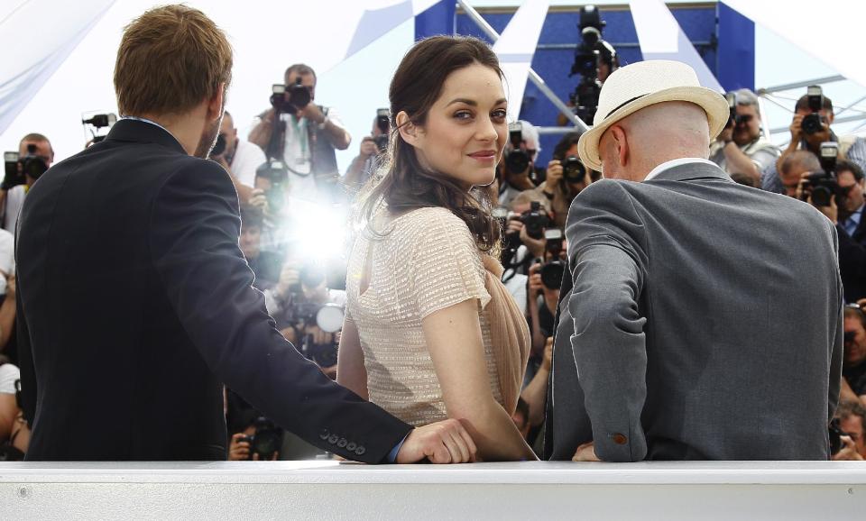 From left, actors Matthias Schoenaerts, Marion Cotillard and director Jacques Audiard pose during a photo call for Rust and Bone at the 65th international film festival, in Cannes, southern France, Thursday, May 17, 2012. (AP Photo/Francois Mori)