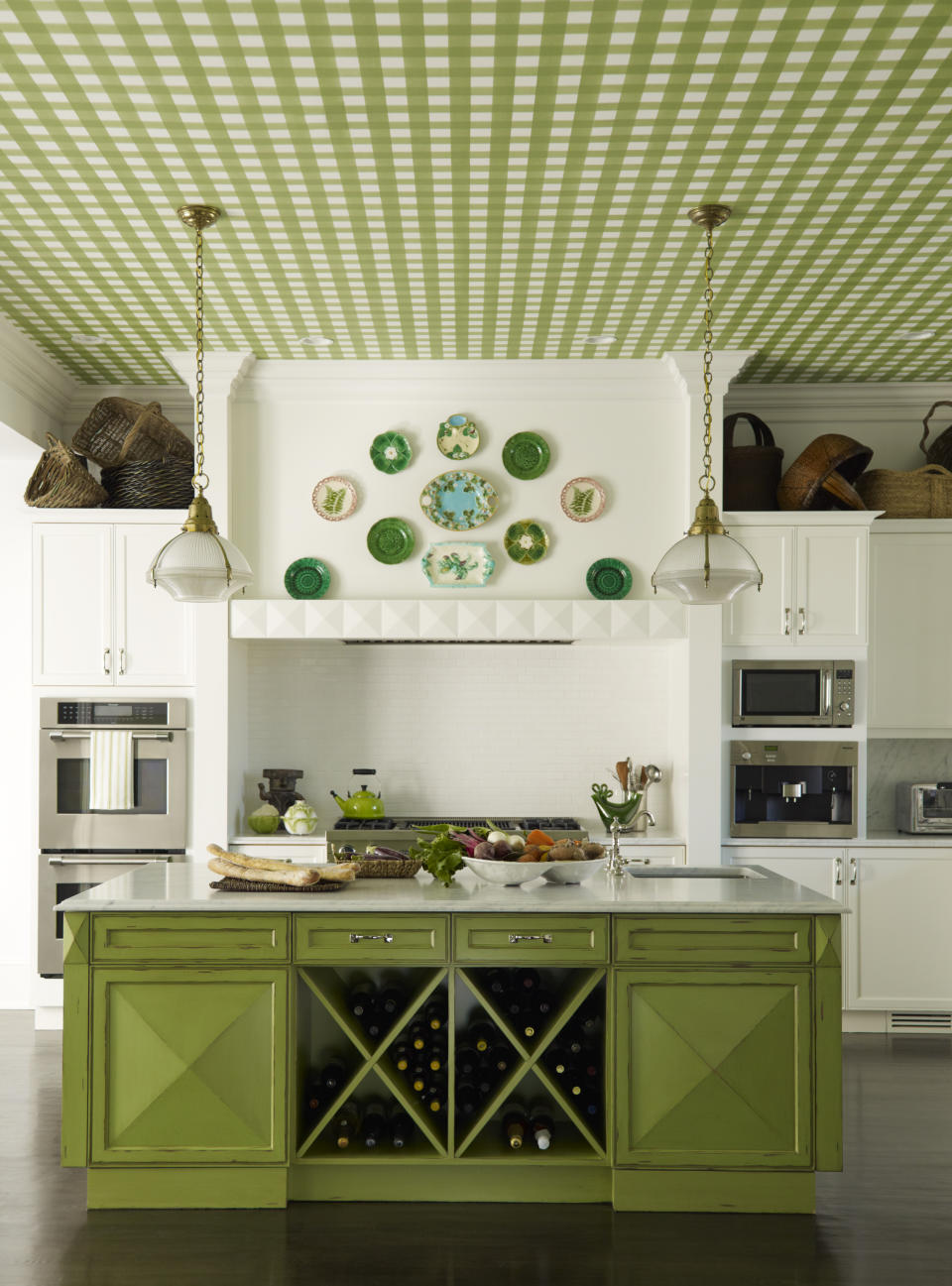 This undated photo shows a kitchen designed by Gideon Mendelson in Westchester County in New York. Mendelson was tasked with creating a classic white kitchen, but he wanted to add some personality. "Statement ceilings are a great way to bring detail and visual interest to a room, and I think that more and more, ceilings aren't being ignored," says Mendelson. "We see them as an opportunity to create something unexpected that adds to the space." "The client loved checks and plaids, so a decorative painter painted a green checkered design on a canvas and then installed it on the ceiling. The color matches the green on the kitchen island, so it ties the room together and makes the space feel that much more special." (Eric Piasecki/Gideon Mendelson/Mendelson Group via AP)