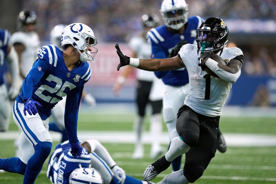 Jacksonville Jaguars running back Travis Etienne Jr. (1) slips past Indianapolis Colts safety Rodney Thomas II (25) on his way to a touchdown run during the second half of an NFL football game Sunday, Sept. 10, 2023, in Indianapolis. (AP Photo/Darron Cummings)