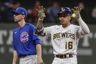 Milwaukee Brewers' Kolten Wong reacts to his double in front of Chicago Cubs' Matt Duffy during the fourth inning of a baseball game Friday, Sept. 17, 2021, in Milwaukee. (AP Photo/Morry Gash)