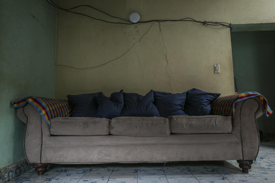 A living room sofa that is used by women going through self-induced abortions sits inside the home of an abortion guide who gives physical and emotional support to them in an undisclosed town of Honduras, Saturday, March 18, 2023. Honduras has one of the world’s strictest abortion bans, with a constitutional prohibition on terminating pregnancy in all cases, even rape. (AP Photo/Ginnette Riquelme)