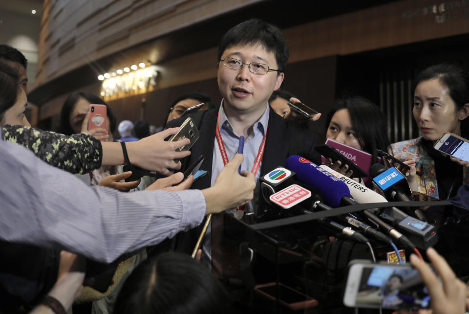 Feng Zhang, center, an institute member of Harvard and MIT's Broad Institute, reacts to reporters on the issue of world's first genetically edited babies after the Human Genome Editing Conference in Hong Kong, Tuesday, Nov. 27, 2018. He Jiankui, a Chinese researcher, claims that he helped make the world's first genetically edited babies twin girls whose DNA he said he altered with a powerful new tool capable of rewriting the very blueprint of life. If true, it would be a profound leap of science and ethics. (AP Photo/Vincent Yu)