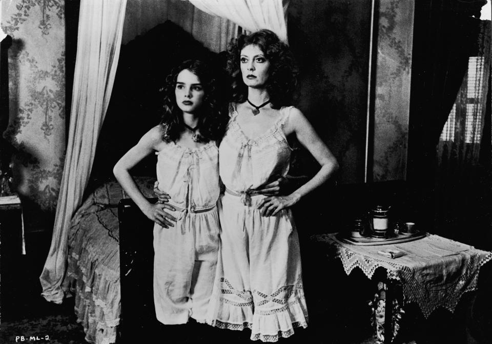 American actors Susan Sarandon (R) and Brooke Shields stand together, wearing matching slips in a still from the film, &#39;Pretty Baby,&#39; directed by Louis Malle, 1975. (Photo by Paramount Pictures/Courtesy of Getty Images)