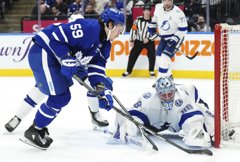 Tampa Bay Lightning goaltender Andrei Vasilevskiy (88) makes a save against Toronto Maple Leafs' Tyler Bertuzzi (59) during the second period of an NHL hockey game Wednesday, April 3, 2024, in Toronto. (Chris Young/The Canadian Press via AP)