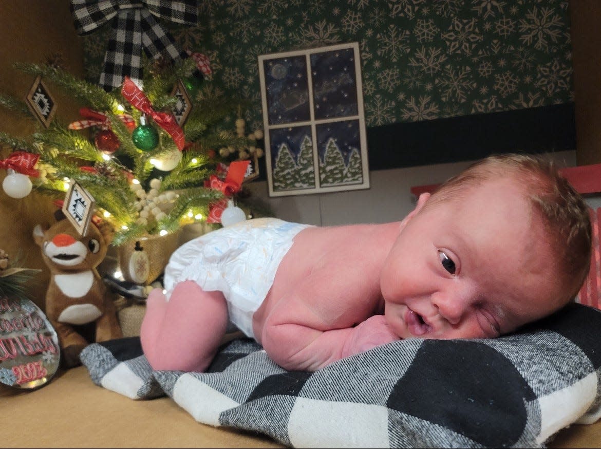 Hadley, a baby born 24 days before she was due, has her photo taken in a Christmas box scene the Aurora Medical Center NICU team made for the holidays.