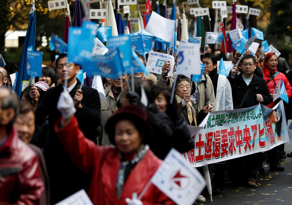 Protesters demanding return of disputed islands claimed by both Japan and Russia, called the Northern Territories in Japan and the Southern Kuriles in Russia, march in Tokyo, Japan December 1, 2016, ahead of Russian President Vladimir Putin's visit to Japan this month. REUTERS/Issei Kato